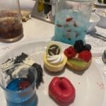 Selection of desserts at PYM Kitchen in Disneyland Paris including colourful mini cakes and themed treats