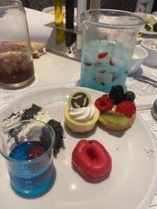 Selection of themed desserts at Disneyland Paris including colourful cakes and mini treats