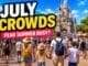 Disneyland Paris July crowds guide showing busy summer park with large crowds walking toward castle in bright sunshine